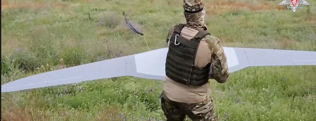 A still from the Russian Ministry of Defence shows a soldier in Ukraine launching reconnaissance drones